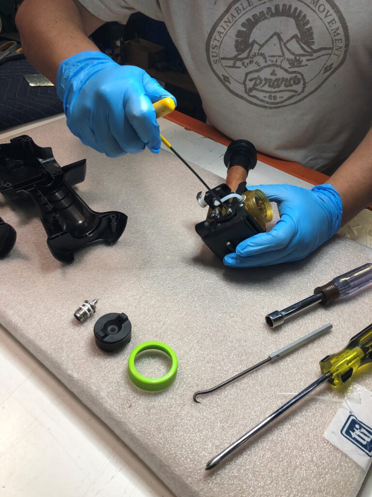Repair Technician Repairing Spray Gun Apllictor
